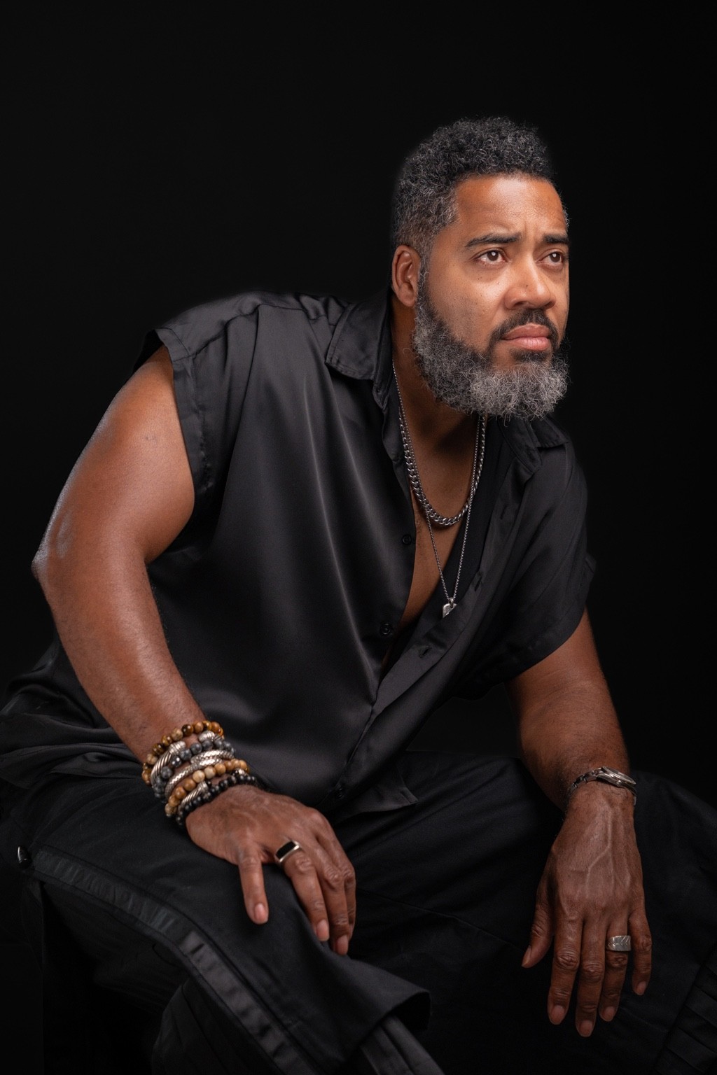 Portrait of Milton Miller seated in a black shirt