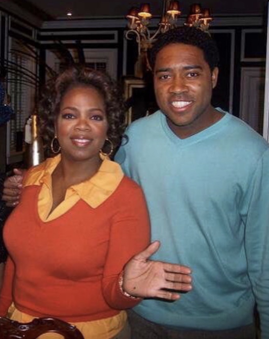 Dr. Milton Miller Jr. posing with a guest in an interior