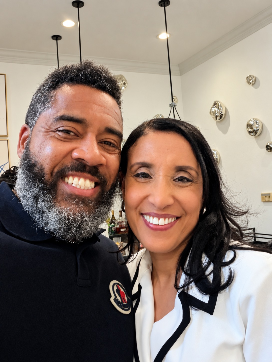 Dr. Milton Miller Jr. and a guest smiling at a gathering