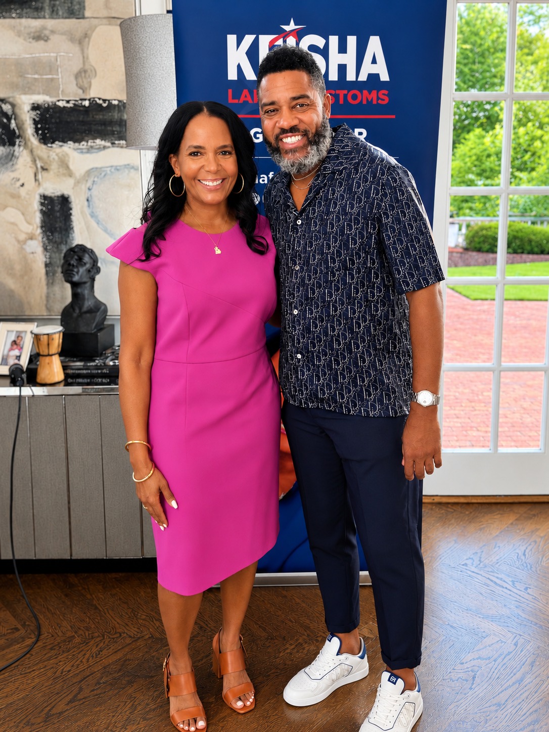 Dr. Milton Miller Jr. and a guest at an indoor gathering