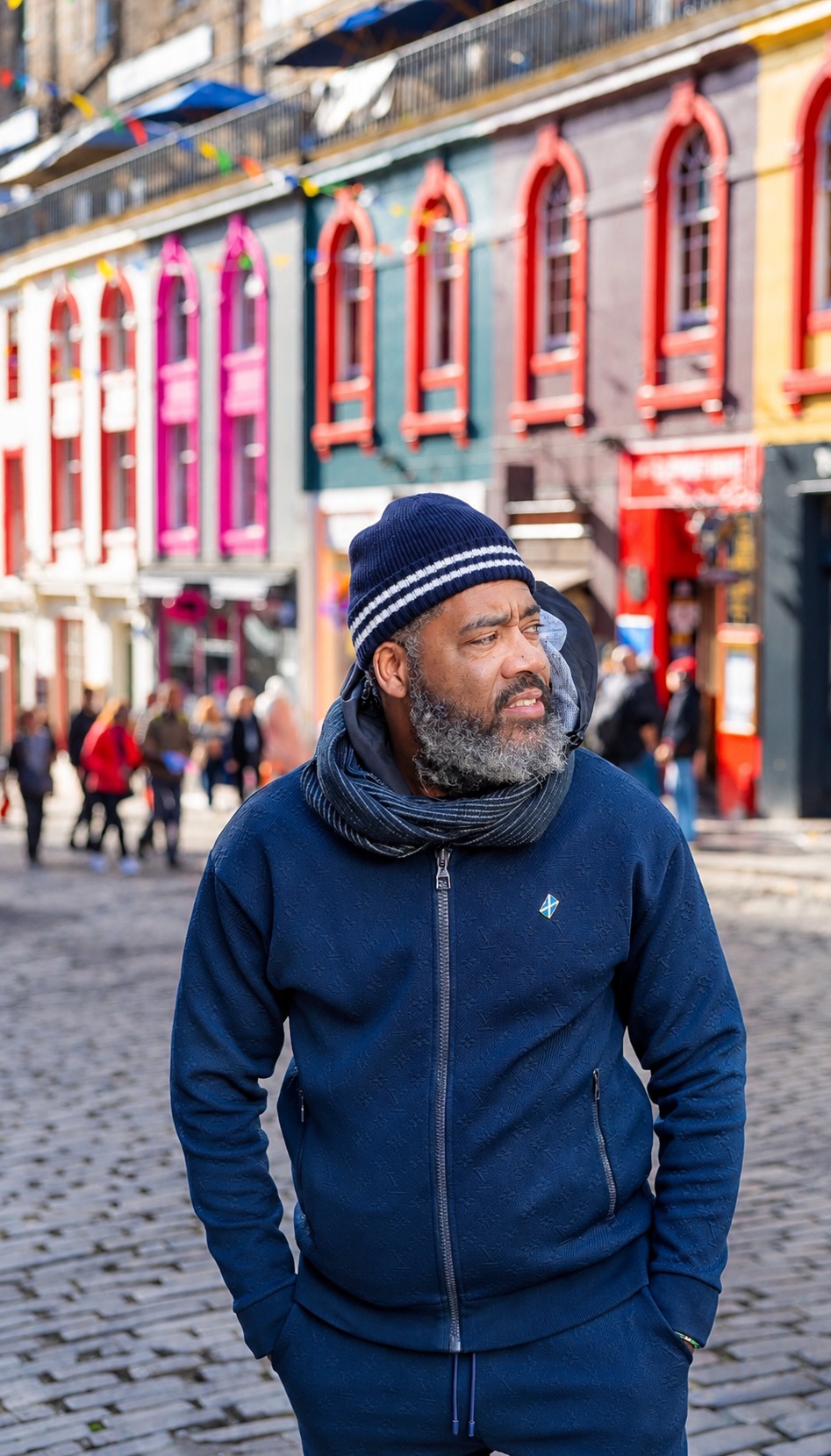 Dr. Milton Miller Jr. in navy winter clothing on a colorful city street