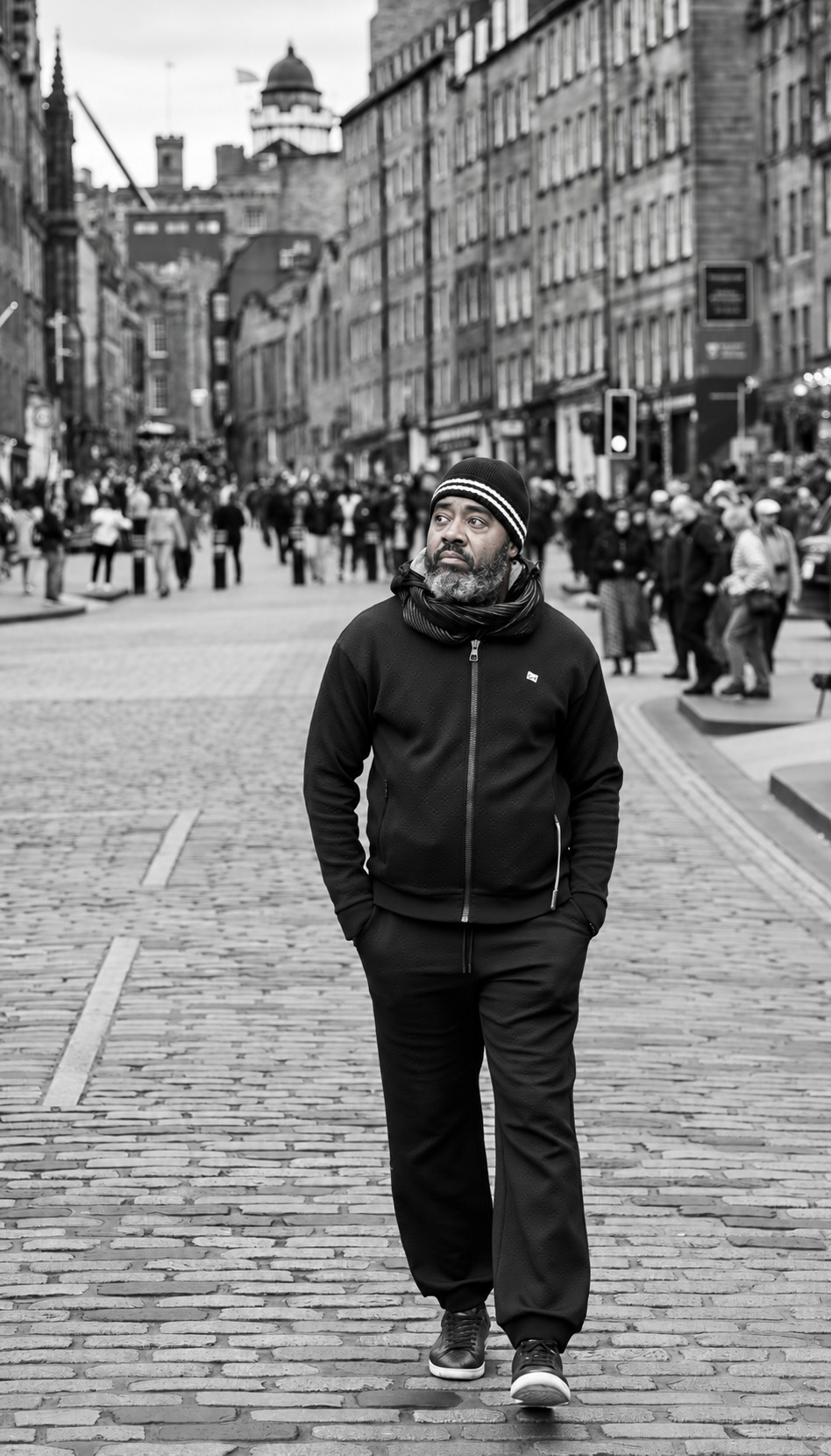 Black-and-white portrait of Dr. Milton Miller Jr. walking along a cobbled city street