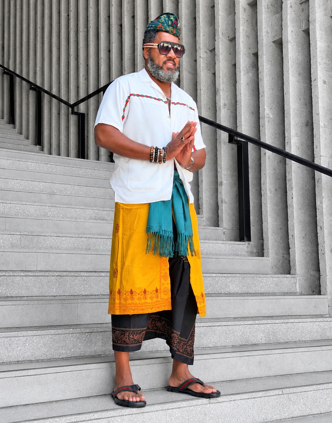 Dr. Milton Miller Jr. in colorful attire on stone steps