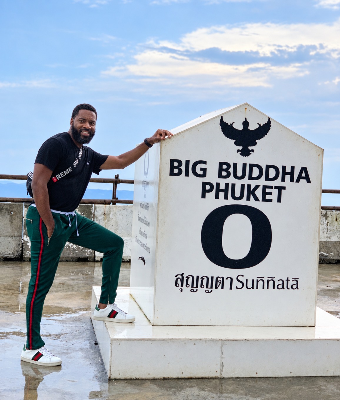 Dr. Milton Miller Jr. beside the Big Buddha Phuket sign